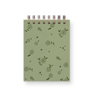 May include: A green spiral bound notebook with a floral pattern embossed on the cover.