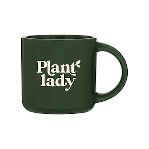 May include: A dark green ceramic mug with a white design that says "Plant lady" with a small leaf next to the word "Plant".