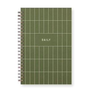 Small Spiral bound planner with grid on cover that reads "daily"