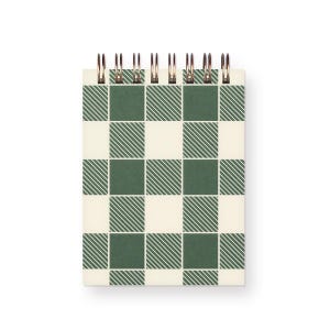 May include: A small, spiral-bound notebook with a green and cream checkered pattern. The cover features a grid design with alternating green and cream squares, each with diagonal lines. The spiral binding is made of copper-coloured metal.