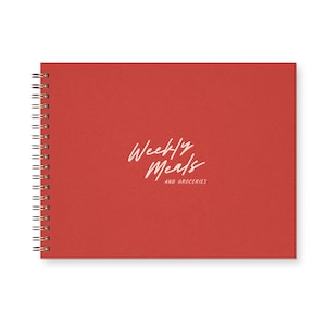 May include: A red spiral bound notebook with the text "Weekly Meals and Groceries" in white.
