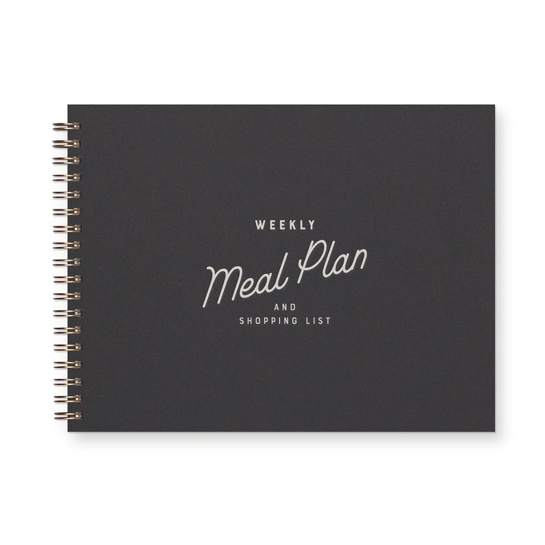 Spiral bound weekly meal planning organizer book with script font that reads " weekly meal plan and shopping list" The book is black with a white font.