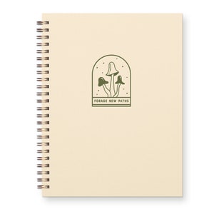 Beige spiral bound notebook for nature lovers with mushrooms on cover that reads "forage new paths"