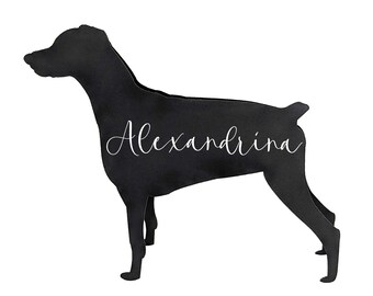 May include: Black silhouette of a dog with the name "Alexandrina" in white script. The dog is standing in profile, with its head and tail raised. The background is plain white.