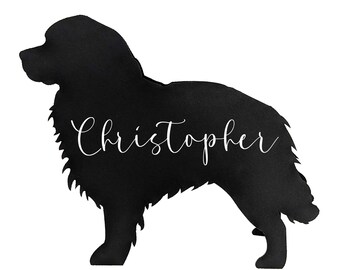 May include: A black silhouette of a dog with the name "Christopher" in white cursive script. The dog is standing in profile, with a fluffy coat and a friendly posture. The background is plain white.