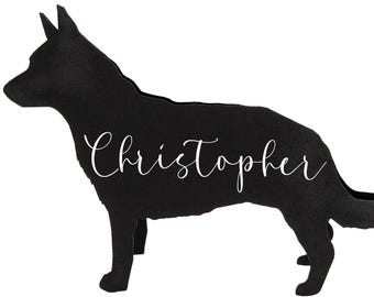 May include: A black silhouette of a dog with the name "Christopher" in white script. The dog is standing in profile, with its head and tail raised. The background is plain white.