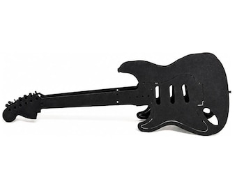 May include: A matte black, flat-pack style electric guitar silhouette constructed from layered material. The design features a long neck with a headstock, a contoured body with cutouts for pickups, and a bridge area, presented as a side profile view.