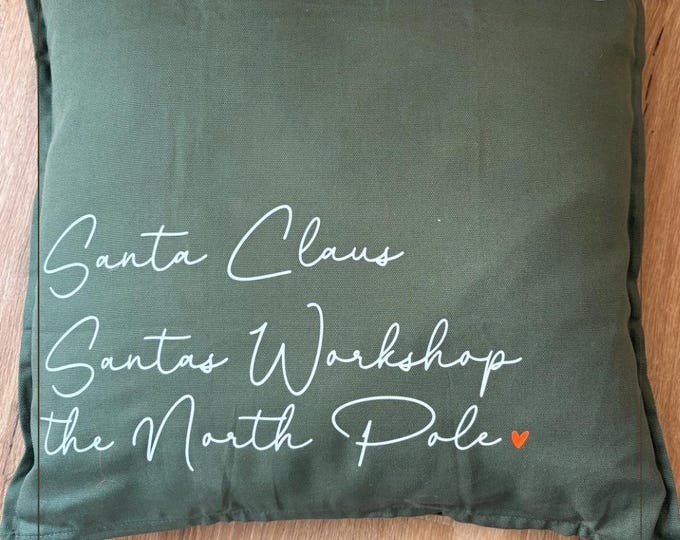 Christmas cushion “Santa Claus – North Pole Delivery” | Decorative cushion cover in postcard style | Christmas decoration in khaki with white lettering