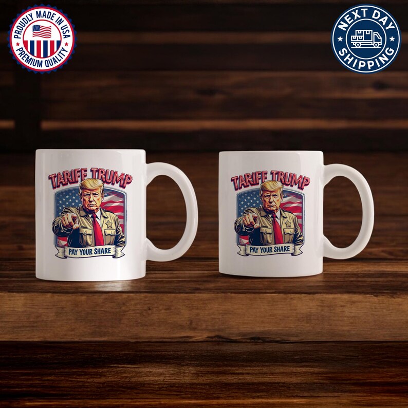 May include: Two white ceramic mugs with a graphic of Donald Trump in a sheriff's uniform with the text "Tariff Trump Pay Your Share" and an American flag in the background.