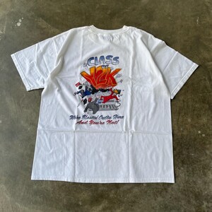 May include: White t-shirt with a graphic design on the back. The design features the text "CLASS OF 2K" in orange and blue, with cartoon figures and the phrase "We're Blessed Outta Here And You're Not!"
