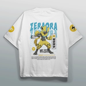 May include: White t-shirt featuring a yellow and black Zeraora graphic with the text "Zeraora" in blue. The shirt also includes Japanese text and the number "887". A yellow lightning bolt is on the sleeve.