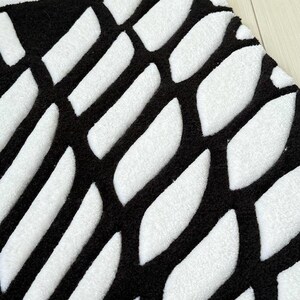 Hand tufted anime rug in irregular shape, bold blue and white wings design, soft textured desk mat