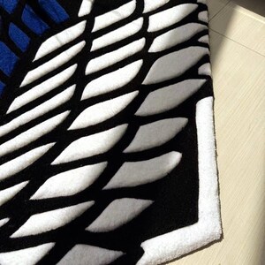Handmade otaku rug placed near white desk and shelving unit