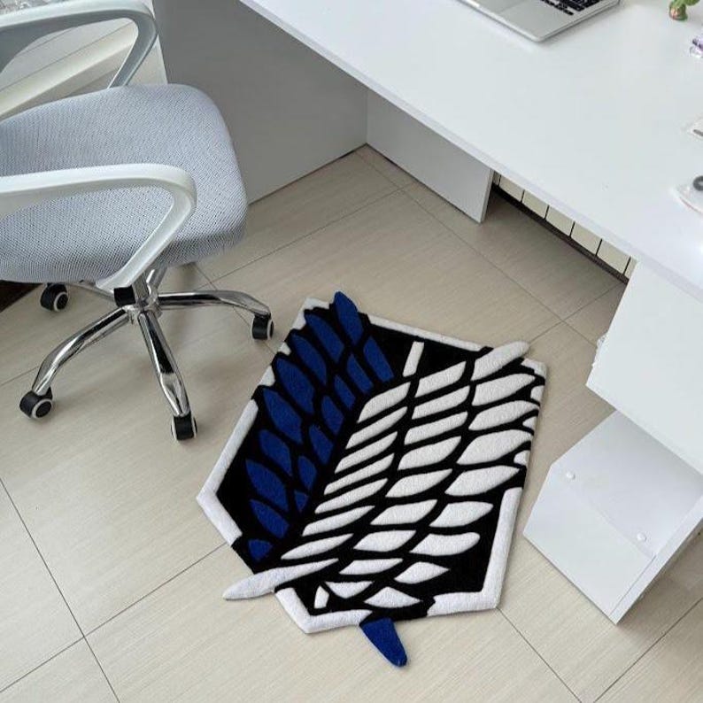 Handmade wing rug positioned in minimalist bedroom workspace area