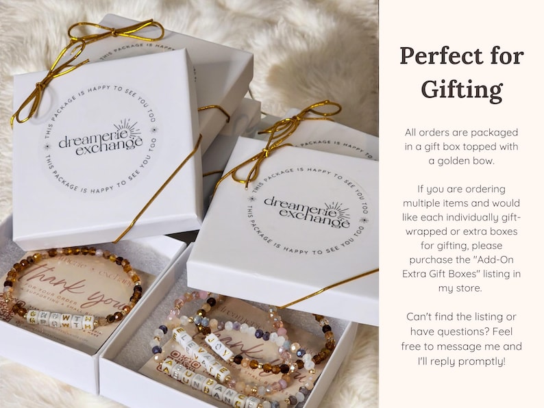 May include: White gift boxes with gold ribbon and a logo that says "dreamerie exchange". The boxes contain beaded bracelets with letter beads that spell out "thank you". The text "Perfect for Gifting" is in the upper right corner of the image. The text below explains that all orders are packaged in a gift box topped with a golden bow.  The text also explains that extra gift boxes can be purchased for multiple items.
