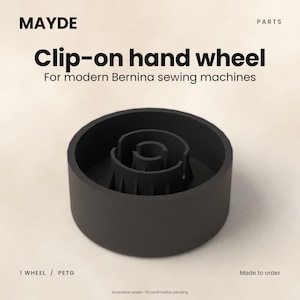 May include: A black clip-on hand wheel for modern Bernina sewing machines by MAYDE. The circular component features a central internal structure with ribbed detailing. Text on the image reads: MAYDE, PARTS, Clip-on hand wheel, For modern Bernina sewing machines, 1 WHEEL / PETG, Made to order, Illustrative render - fit confirmation pending.