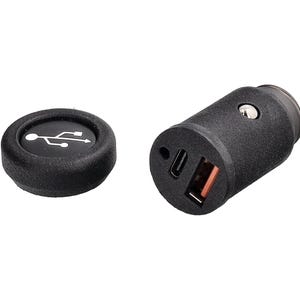 Może przedstawiać: Czarna ładowarka samochodowa USB z teksturowanym wykończeniem. Ładowarka posiada port USB-A i USB-C oraz małą okrągłą nasadkę z symbolem USB. Zaprojektowana do podłączenia do zapalniczki samochodowej.