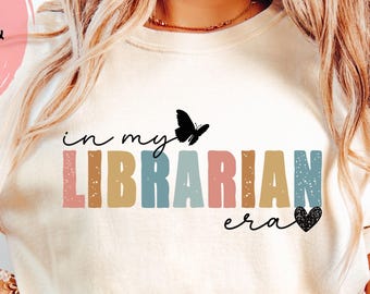 May include: Cream-colored t-shirt with the text "in my LIBRARIAN era" in colorful block letters, a black butterfly, and a black heart. The image also includes text that says "4 Different PNG files & SVG file".