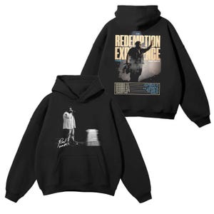 May include: Black hoodie featuring a graphic of a person with the text "The Redemption Experience Tour" and tour dates. The front of the hoodie has a black and white image of a person with the artist's signature.