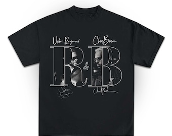 Puede incluir: Camiseta negra con un diseño gráfico blanco que presenta el texto "R&B" y los nombres "Usher Raymond" y "Chris Brown". El diseño incluye imágenes en blanco y negro de los artistas y sus firmas.
