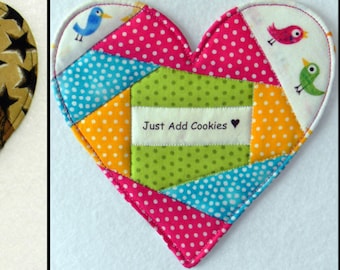 May include: Six handmade heart-shaped fabric coasters with different patterns and sayings. The sayings include "Love is All Around You", "Happiness", "Best. Dad. Ever.", "I ♥ Coffee", "Honey", and "Just Add Cookies".