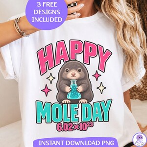 May include: A white t-shirt featuring a graphic of a brown mole holding a teal chemistry flask. The text reads HAPPY MOLE DAY 6.02x10^23 in pink and teal lettering. The design includes small pink and yellow four-pointed star accents.