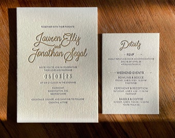 May include: A wedding invitation with gold lettering on a cream cardstock. The invitation reads "Lauren Ellis and Jonathan Segal" with the wedding date "06/08/23" and the location "Fairmont, Washington, DC. Georgetown". The invitation also includes details about the wedding weekend events, including bowling and bocce, a ceremony and reception, and bagels and coffee.