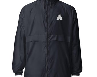 May include: Navy blue windbreaker jacket featuring a white castle silhouette on the chest. The jacket has a full zip, a stand-up collar, and a drawstring hem. A lightweight, casual outerwear garment.