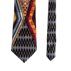 May include: A patterned necktie with a black, gray, red, and gold design. The tie features geometric shapes, including diamonds and stripes. The tie is displayed on a white background.