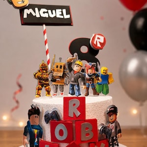 May include: A white frosted cake decorated with Roblox character figurines and red blocks spelling "ROBLOX". The cake has a sign that says "MIGUEL" and a large number "8" with a Roblox logo. Balloons are in the background.