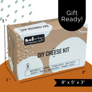May include: A rectangular DIY cheese kit box, measuring 8" x 5" x 3", with the text "DIY CHEESE KIT" in large letters. The box includes the "Urban Cheesecraft" logo and lists cheese types like mozzarella and goat cheese. The words "Gift Ready!" are also visible.