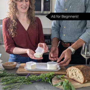 May include: A person holding a square cheese mold with a block of fresh cheese. Two other cheese molds with cheese are on a decorative tray. The image includes the text "All for Beginners!" and a loaf of bread.