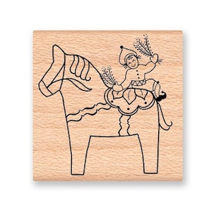 May include: A wooden stamp with a black line drawing of a traditional Swedish Dala horse with a person riding on top. The person is holding a branch with leaves in each hand.
