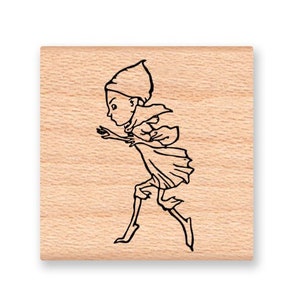 May include: A wooden stamp featuring a black line drawing of a person running. The person is wearing a hat and a long coat.