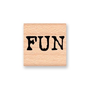 May include: A wooden stamp with the word "FUN" printed in black ink.