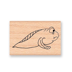 May include: A wooden rubber stamp with a black line drawing of a cartoon fish with a large eye and a small mouth.