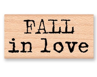 May include: Wooden stamp with the text "FALL in love" in a vintage typewriter font.
