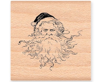 May include: A vintage-style wood mounted rubber stamp featuring a black and white illustration of Santa Claus's face with a long beard and a hat.