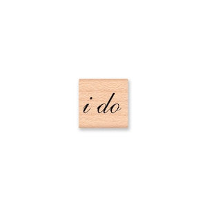 May include: Wooden stamp with the text "i do" in a cursive font.