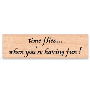 May include: Wooden stamp with the text "time flies... when you're having fun!"
