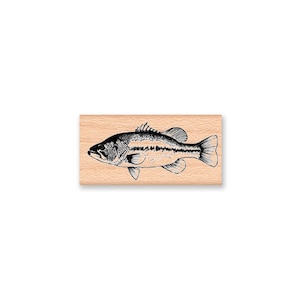May include: A black and white illustration of a bass fish on a wooden block.