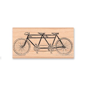 May include: A black and white illustration of a vintage tandem bicycle with two seats and two sets of pedals.