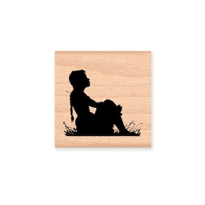 May include: Black silhouette of a person sitting with their legs crossed, looking up at the sky. The person is sitting in a field of grass.