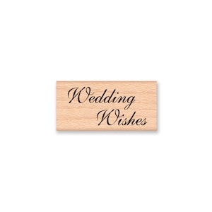 May include: Wooden stamp with the text "Wedding Wishes" in a cursive font.