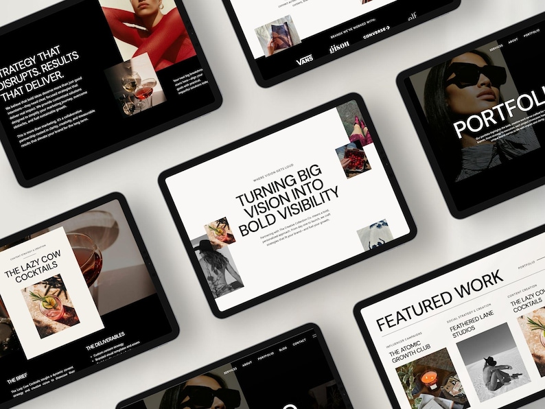 May include: A collection of black tablets displaying website designs with a white background. The tablets showcase text and images, including the phrases "Strategy That Disrupts. Results That Deliver" and "Turning Big Vision Into Bold Visibility."