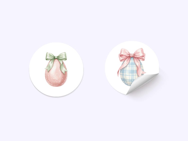 May include: Two round stickers with watercolor Easter egg designs. One sticker features a pink egg with white polka dots and a green bow. The other sticker shows a blue plaid egg with a pink bow and a curled edge.