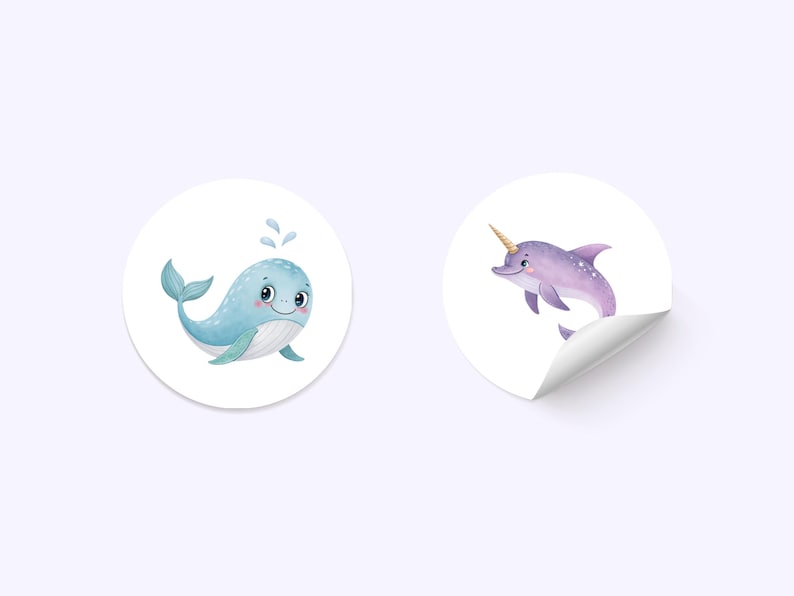 May include: Two round stickers with cartoon illustrations of sea creatures. The first sticker features a blue whale with a white belly and a happy expression. The second sticker features a purple dolphin with a gold horn and a white belly.