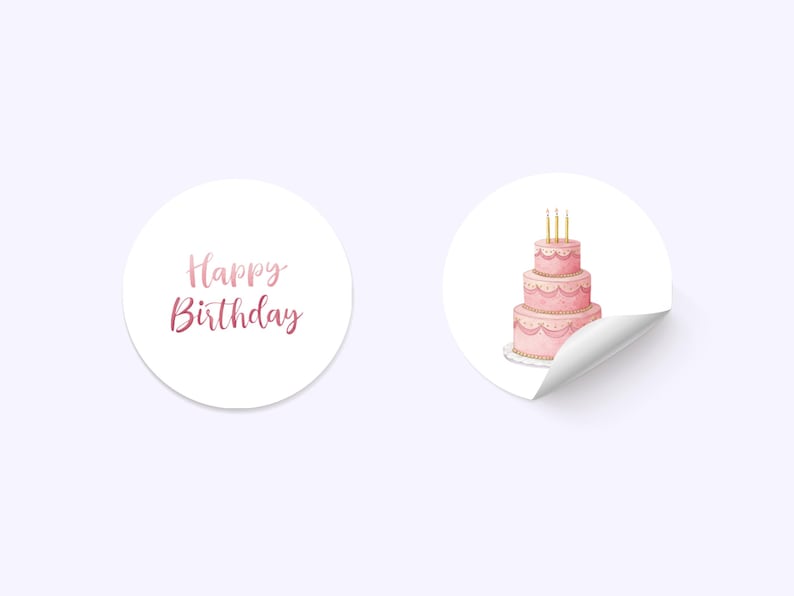 May include: Two white, circular stickers. One displays the text "Happy Birthday" in pink script. The other shows a three-tiered pink cake with gold candles. The cake has decorative icing and sits on a white plate.