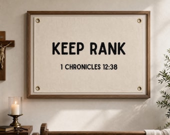May include: A rectangular wall hanging featuring a cream-colored fabric panel with four brass grommets in the corners, framed in dark wood. The text KEEP RANK and 1 CHRONICLES 12:38 are printed in bold black capital letters on the fabric.