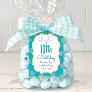 May include: Teal and gold birthday favor tag with white polka dots and the text "Layla's 11th Birthday Thanks for celebrating with me!"